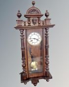 A beech Junghans eight-day wall clock with enamelled dial.
