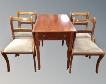 An inlaid yew wood drop leaf dining table and four chairs