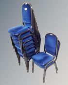 A set of ten metal framed stacking chairs in blue fabric