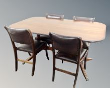 A Regency style pedestal tilt topped dining table on brass capped feet together with a set of four
