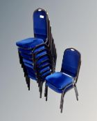 A set of ten metal framed stacking chairs in blue fabric