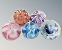 Five round glass paperweights to include Guernesy Isle of White etc