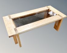 A contemporary oak coffee table with smoked glass panel