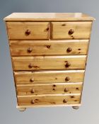 A contemporary pine five drawer chest