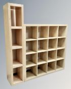 A set of contemporary sixteen hole cube shelves together with a further set of shelves