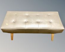 A 20th century duet footstool in golden buttoned vinyl