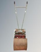 A vintage Ephyre manual lawn mower with grass box