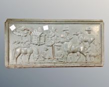 An antique cast iron fireplace plaque depicting wildlife and figures