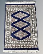 An Afghan/Caucasian rug 64 cm x 92 cm