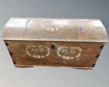A 19th century oak dome topped marriage chest with painted decoration and dated 1849