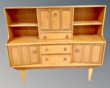 A mid century teak cocktail high board