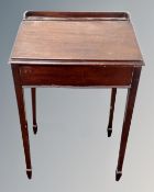 An early 20th century mahogany school desk