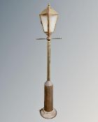 A brass floor lamp in the form of a Victorian street light