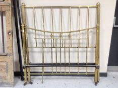 A Victorian brass 4'6 rail bed frame with irons