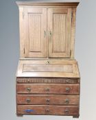 A 19th century continental oak bureau bookcase with four drawers