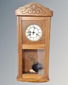 A Junghans 8-day wall clock with pendulum and key