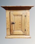 A 19th century pine single door wall cabinet