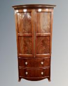 A reproduction mahogany double door bow fronted wardrobe