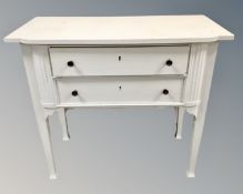A painted oak shaped two tier serving table on raised legs