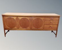A Nathan teak 'Circles' three door cocktail sideboard fitted with three drawers