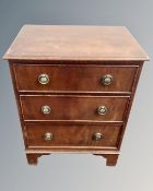 A Regency style three drawer chest with brass drop handles