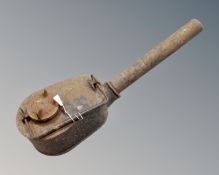 An antique C Wells and company cast iron paraffin torch lamp