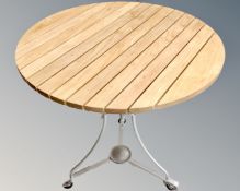 A wooden slatted bistro table on metal legs