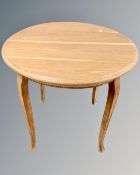 An early 20th century circular oak occasional table