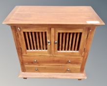 A hardwood double slatted door cabinet fitted with two drawers