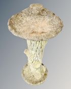 A concrete garden bird bath