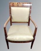 A 19th century mahogany armchair in golden fabric