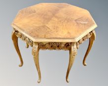An octagonal walnut and carved beech wood coffee table