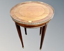 A French marquetry inlaid circular occasional table with brass gallery