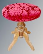 An Edwardian oak circular adjustable dressing table stool
