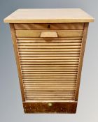 An Edwardian oak shutter door music cabinet