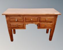 A hardwood five drawer console table