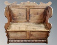 A 19th century oak storage settle