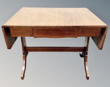 An antique Continental mahogany sofa table