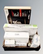 A box of Nintendo Wii, Wii play, Mario Cart Wii, games and balance board, Guitar Hero 5,