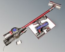 A Dyson V7 total clean hand held vacuum with wall mounting bracket,