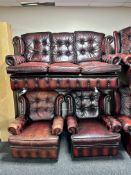 An oxblood buttoned leather three piece Chesterfield lounge suite