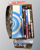 A box of hard back books, novels, dart board, jigsaw,