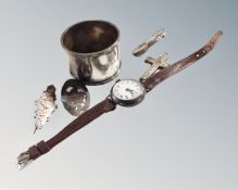 A bag containing silver napkin ring, silver cased wristwatch on leather strap,