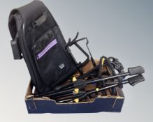A box of assorted guitar stands together with an On Stage guitar bag