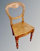 An antique balloon back kitchen chair