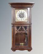 An Art Nouveau 8 day wall clock with brass and silvered dial
