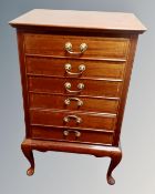 A late 19th century inlaid mahogany six drawer music chest containing sheet music