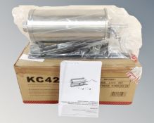 A commercial cylindrical sausage maker, boxed.