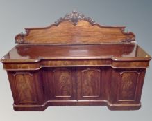 A Victorian mahogany inverted break-front four door sideboard