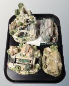 A tray containing four Lilliput Lane ornaments with certificates.